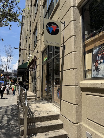 Double-sided projecting blade sign mounted on exterior storefront facade in Portland, OR.