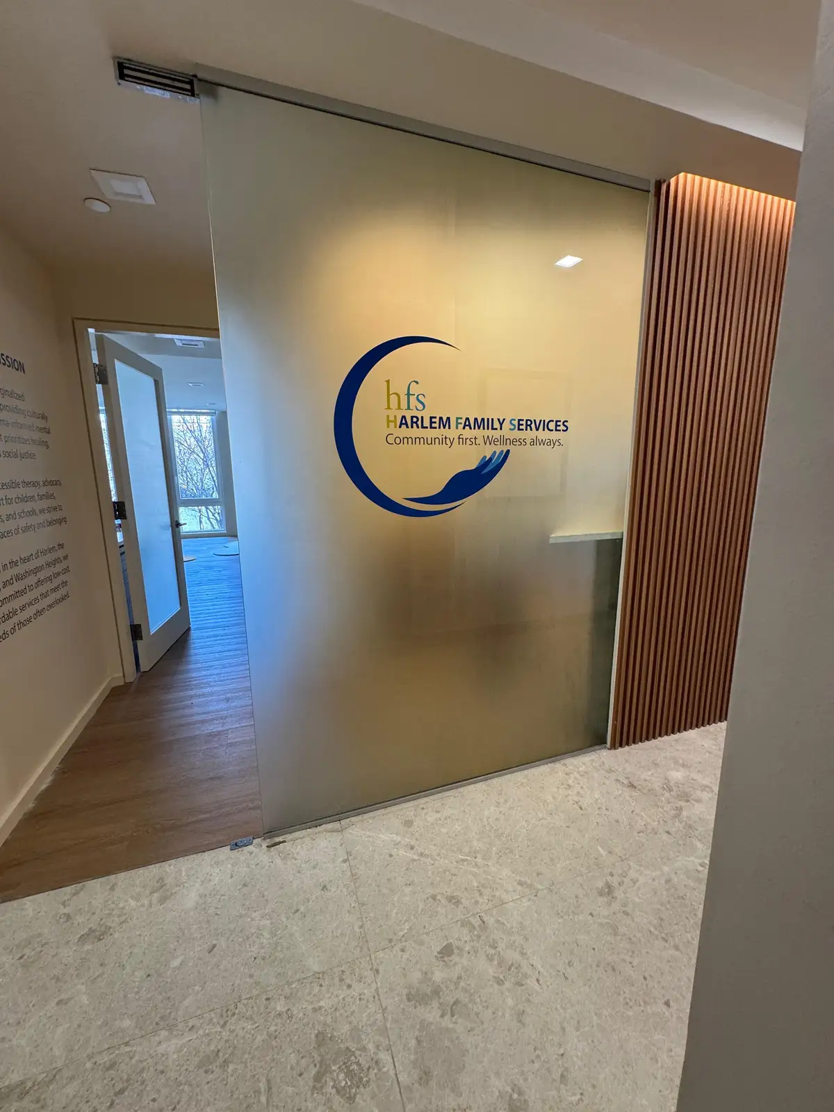 Second-surface cut vinyl logo graphic on glass with translucent film for HFS Soluri, Manhattan, NY.