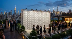 evenly spaced grid of blank logo placeholders, set up at a corporate rooftop event in New York City, evening lighting, skyline visible in the distance, no visible text or logo