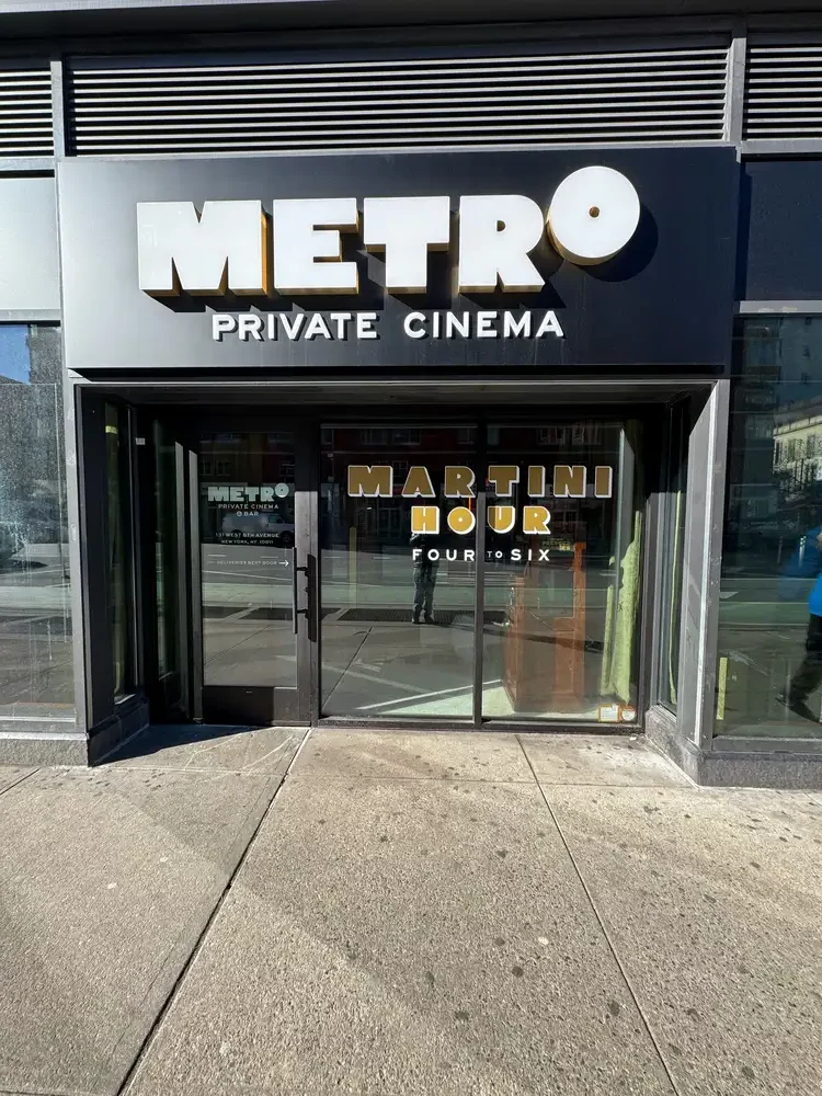 Second-surface glass door vinyl lettering paired with first-surface layered film lettering for Metro Private Cinema, Manhattan, NY.